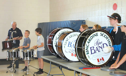Students keep the beat during drumming performance at Elgin Market school