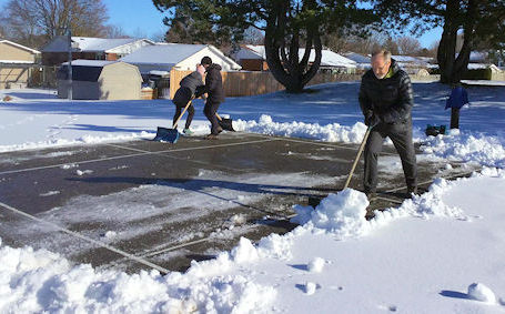 Avid Pickleball players clear snow to play the game outside